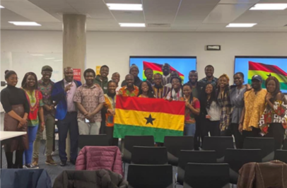 Group of people holding the Ghanaian flag